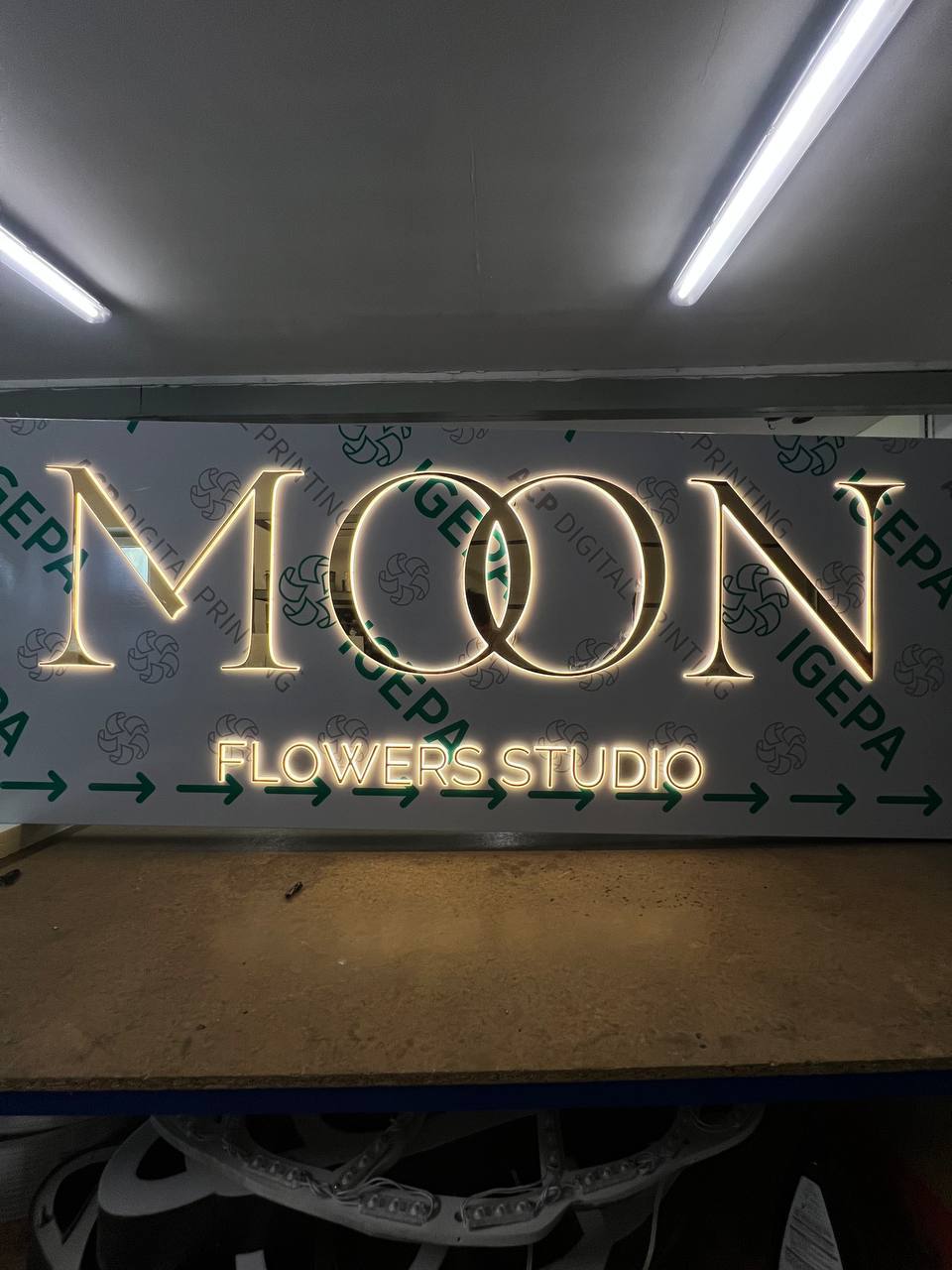 Moon Flowers Studio — Gold halo-lit letters